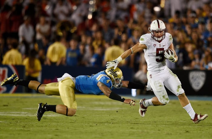 Sep 24, 2016; Pasadena, CA, USA; Stanford Cardinal running back Christian McCaffrey (5) runs the ball past UCLA Bruins linebacker Cameron Judge (4) during the second half at Rose Bowl. The Stanford Cardinal won 22-13. Mandatory Credit: Kelvin Kuo-USA TODAY Sports